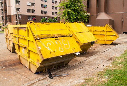Construction site with waste clearance in progress in Mill Hill