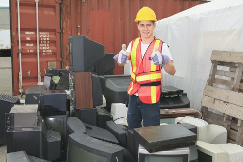 Operatives sorting items during a Mill Hill flat clearance with recycling bins
