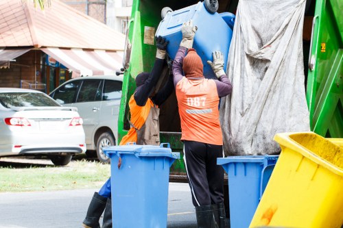 Supervisor reviewing risk assessment paperwork during a flat clearance job